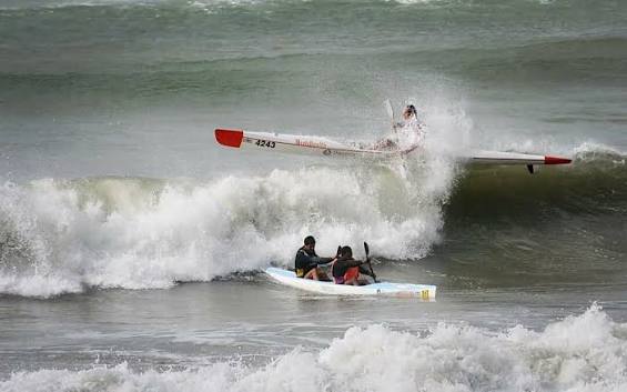 Surfski paddler wiped out by a breaking wave